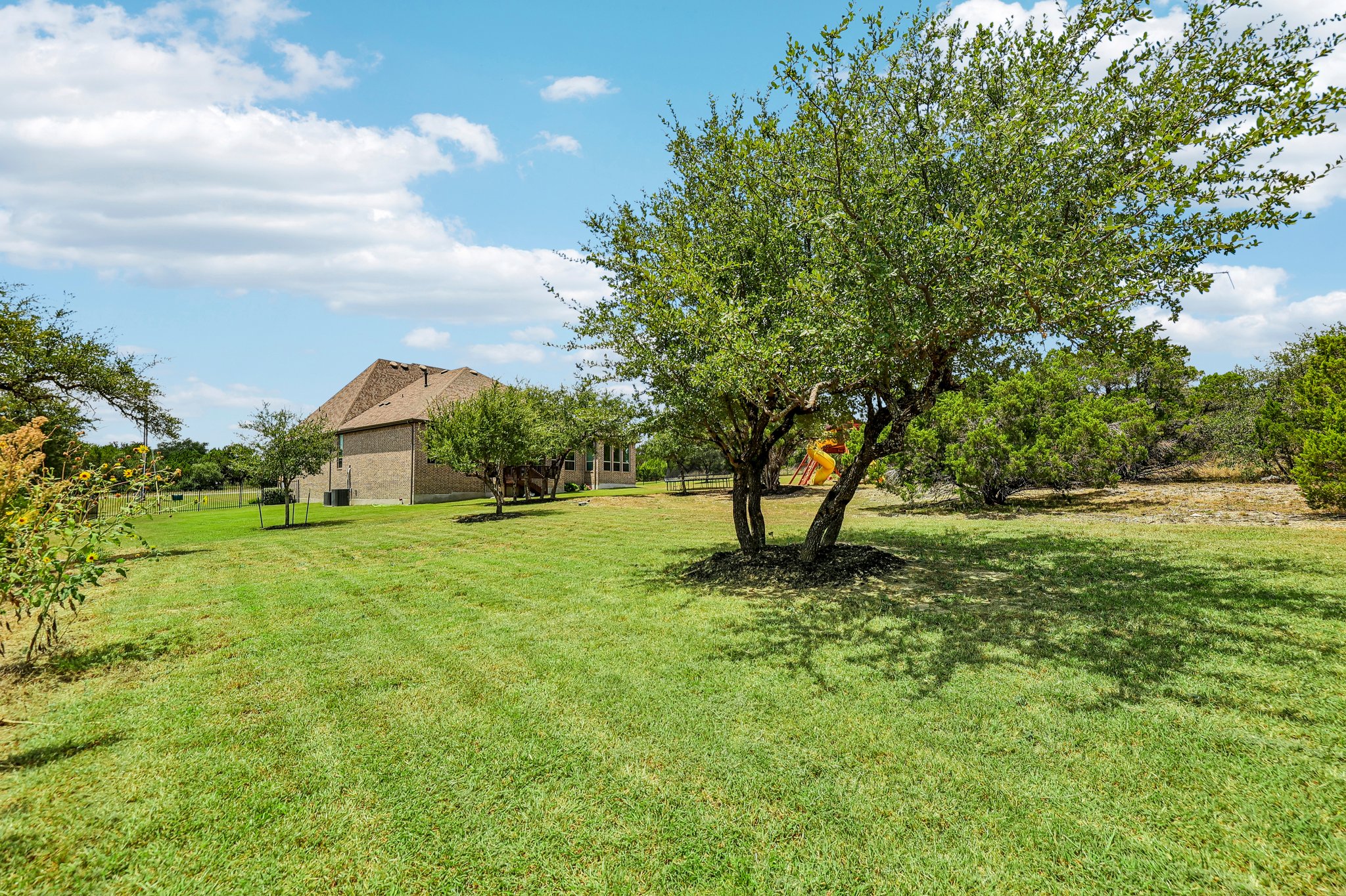 1705 Parten Rnch Parkway Austin, TX 78737 - Photo 31 of 39 A spacious, verdant yard with mature trees offers ample room for outdoor activities.