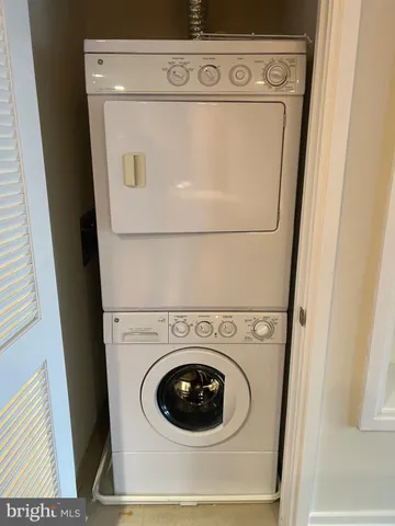 a living room with a couch and a potted plant
