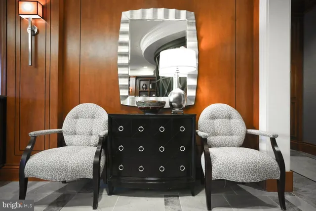 a view of a hallway with furniture and a potted plant