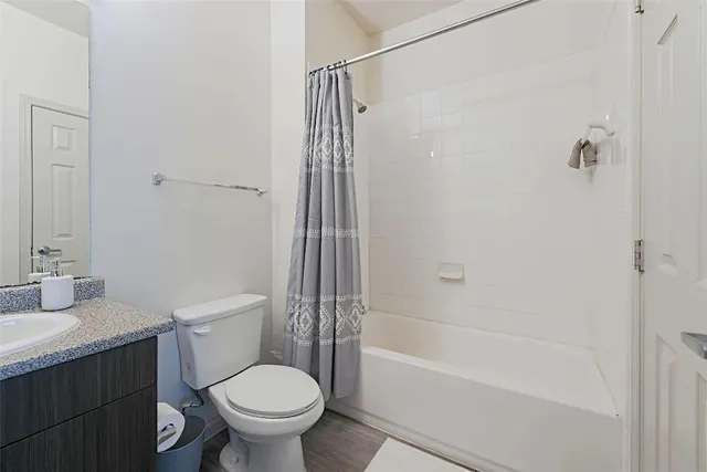 a bathroom with a sink mirror vanity and toilet
