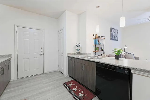 a kitchen with stainless steel appliances a stove microwave and sink