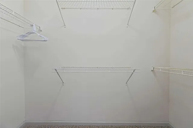 a en suite bathroom with a granite countertop sink and a mirror