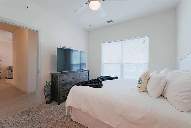 a bedroom with a bed and a chair