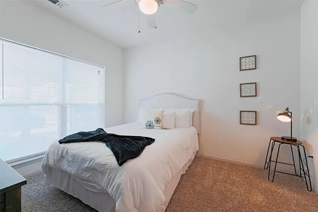 a bedroom with a bed and a table