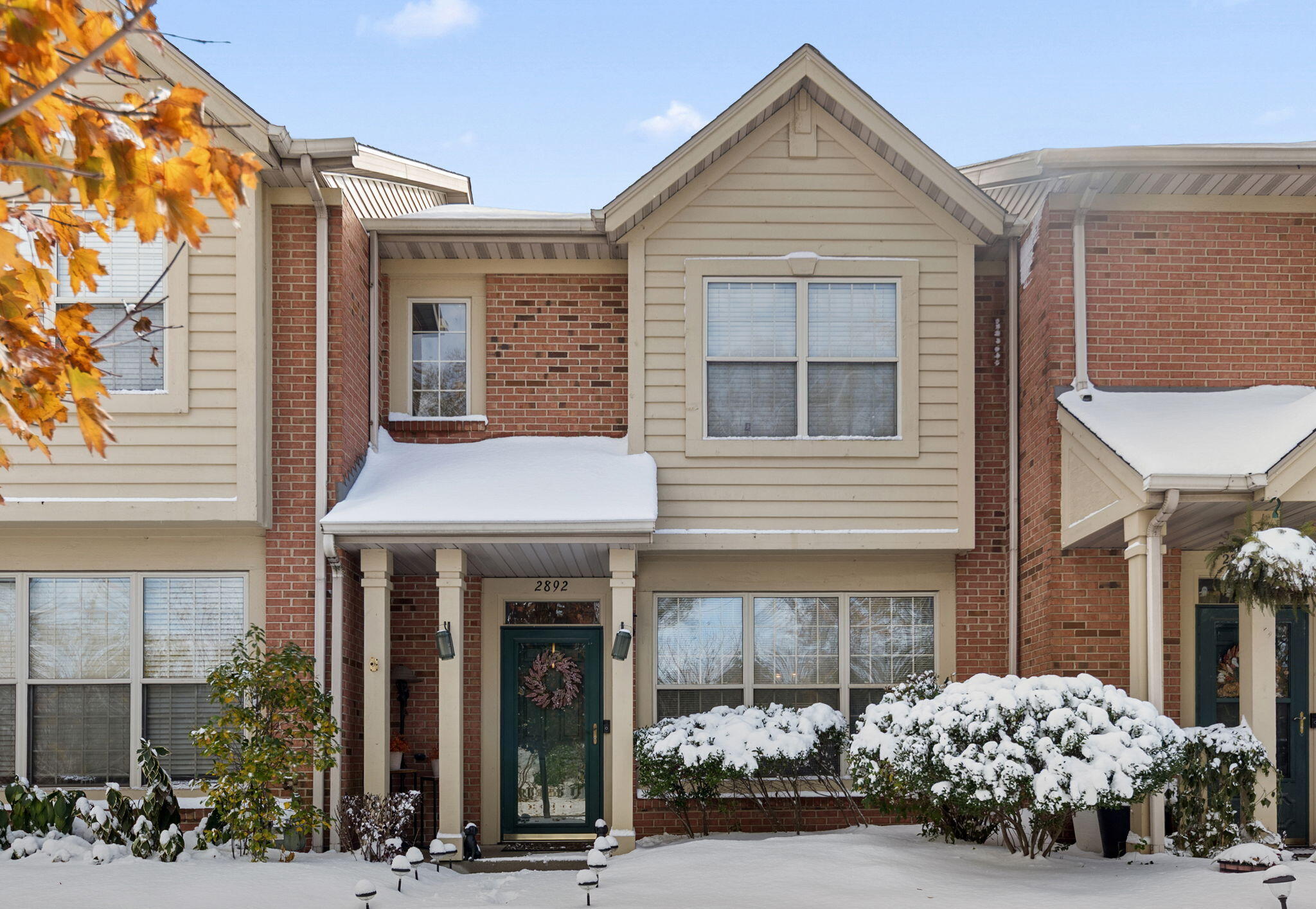a view of a house with potted plants and more windows