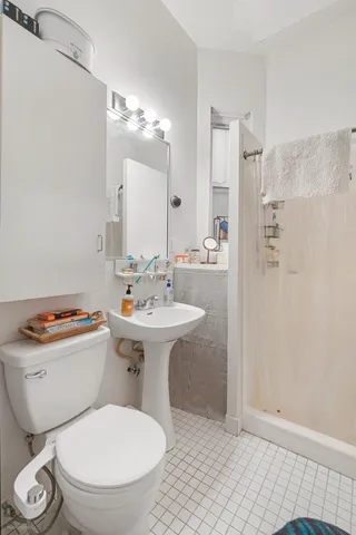 a bathroom with a toilet sink and shower