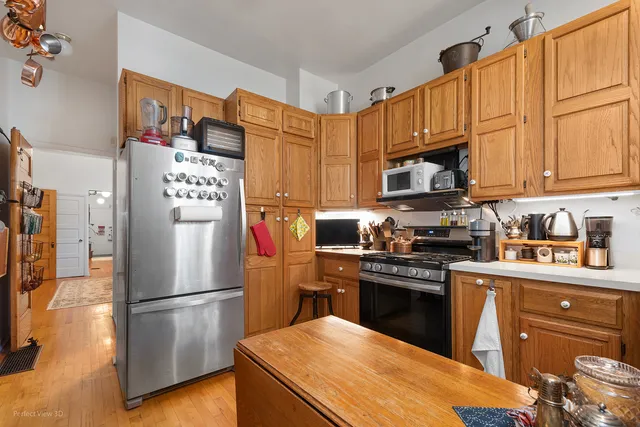a kitchen with stainless steel appliances granite countertop a refrigerator stove top oven a sink and dishwasher