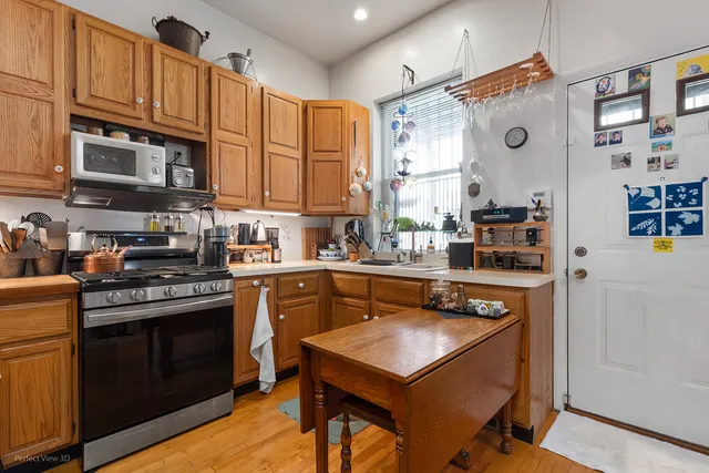 a kitchen with stainless steel appliances granite countertop a sink a stove and cabinets