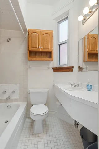 a bathroom with a sink a toilet and bathtub