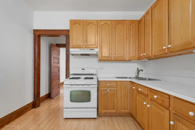 a kitchen with a stove top oven sink and cabinets