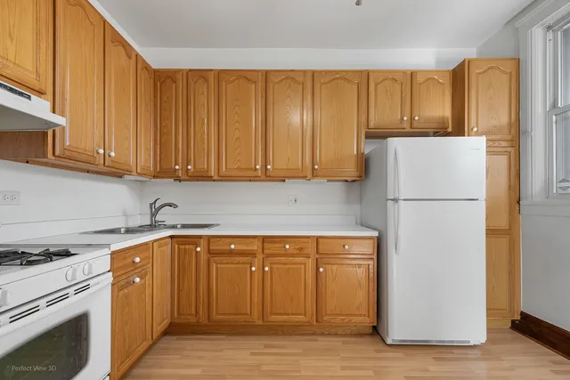 a kitchen with a refrigerator sink and cabinets