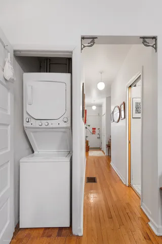 a view of walk in closet with wooden floor