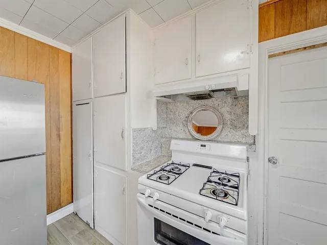 a kitchen with a stove and a refrigerator