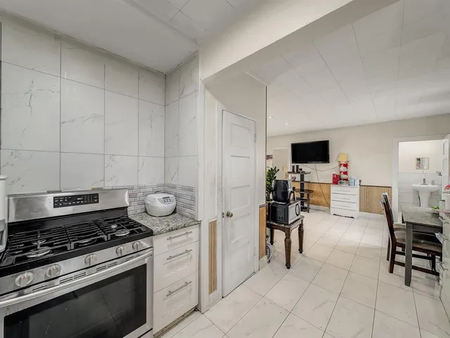 a kitchen with furniture a sink and a stove top oven