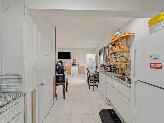 a room with furniture a air conditioner vent and white cabinets