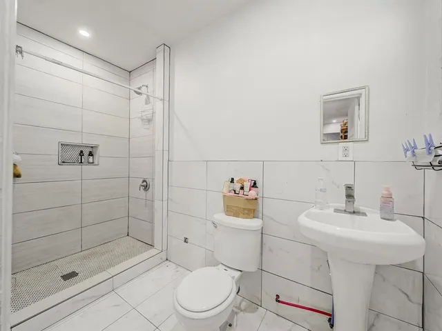 a bathroom with a sink toilet and shower