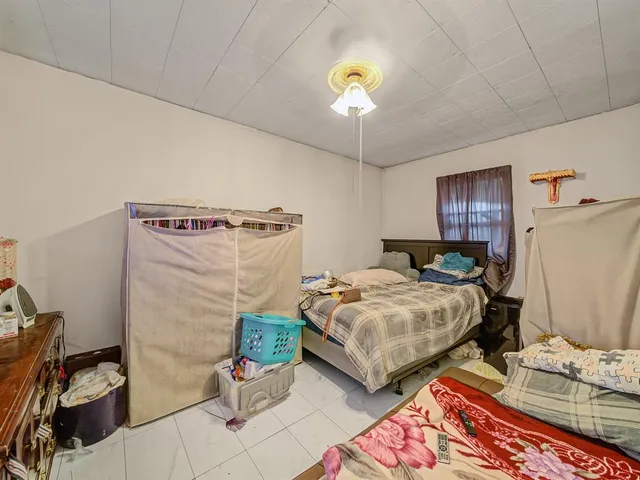 a bedroom with bed and a window