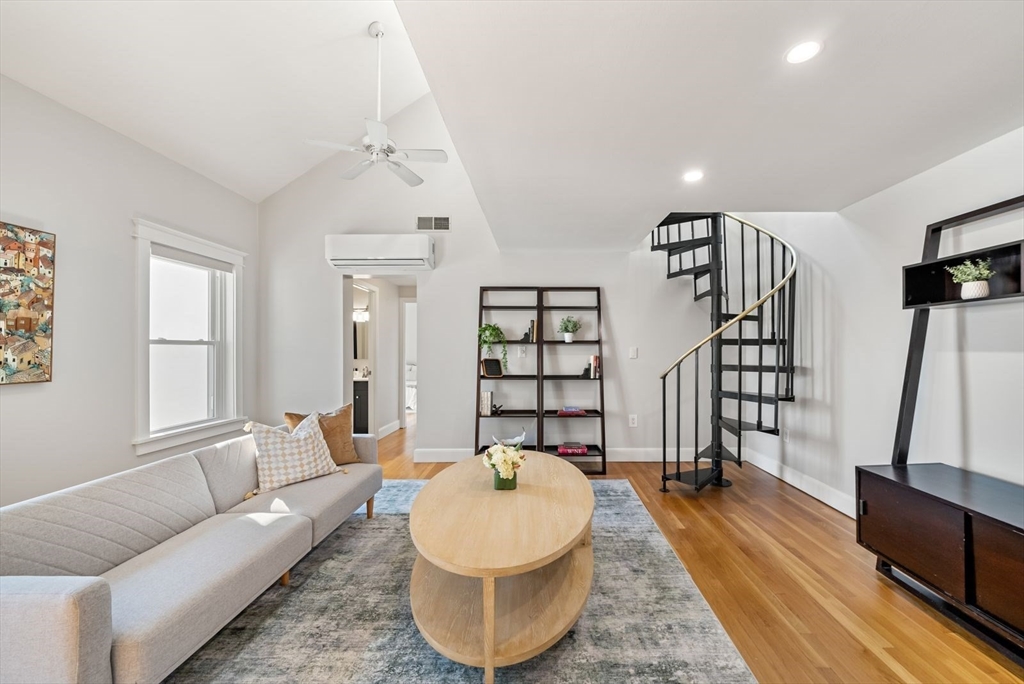 53 North Mead Street, Unit C10 Boston, MA 02129 - Photo 2 of 15 a living room with furniture and a wooden floor
