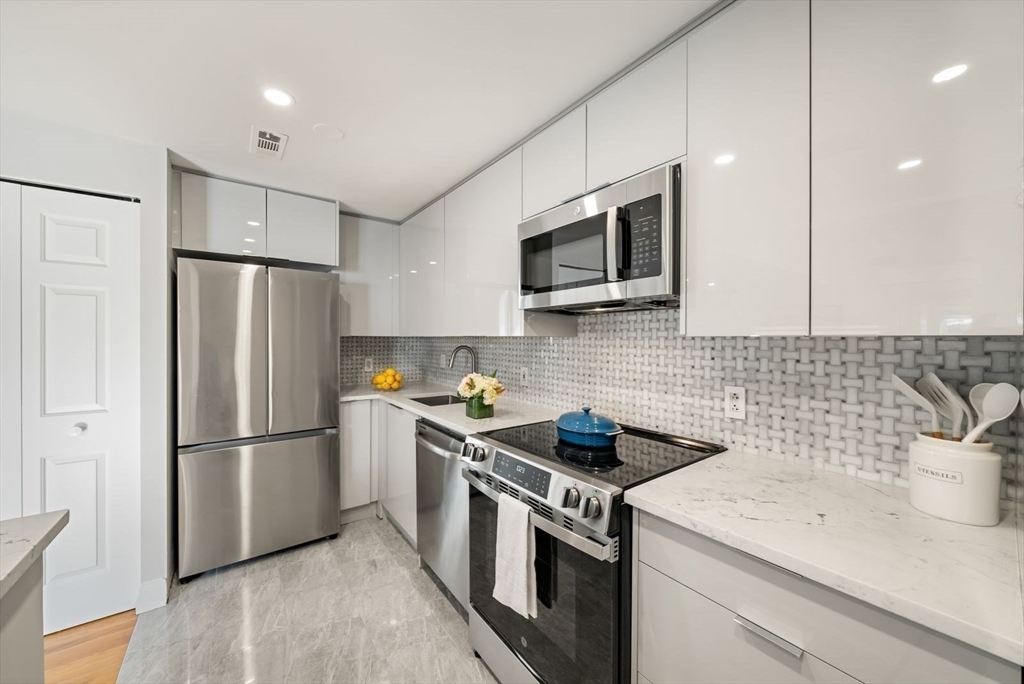 53 North Mead Street, Unit C10 Boston, MA 02129 - Photo 7 of 15 a kitchen with a refrigerator stove and microwave
