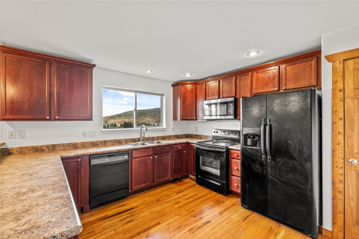 127 Oak Ridge Circle, Unit 104 Oak Creek, CO 80467 - Photo 14 of 26 a kitchen with stainless steel appliances granite countertop a stove refrigerator sink and dishwasher