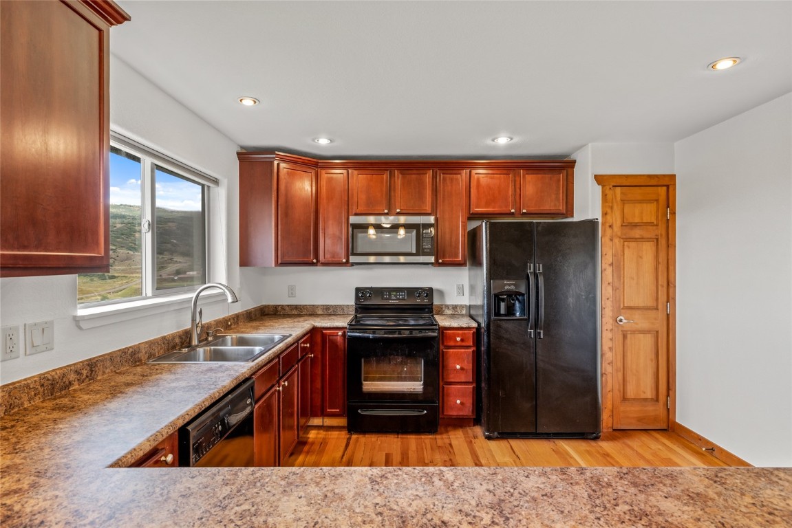 127 Oak Ridge Circle, Unit 104 Oak Creek, CO 80467 - Photo 15 of 26 a kitchen with stainless steel appliances granite countertop a refrigerator and a sink