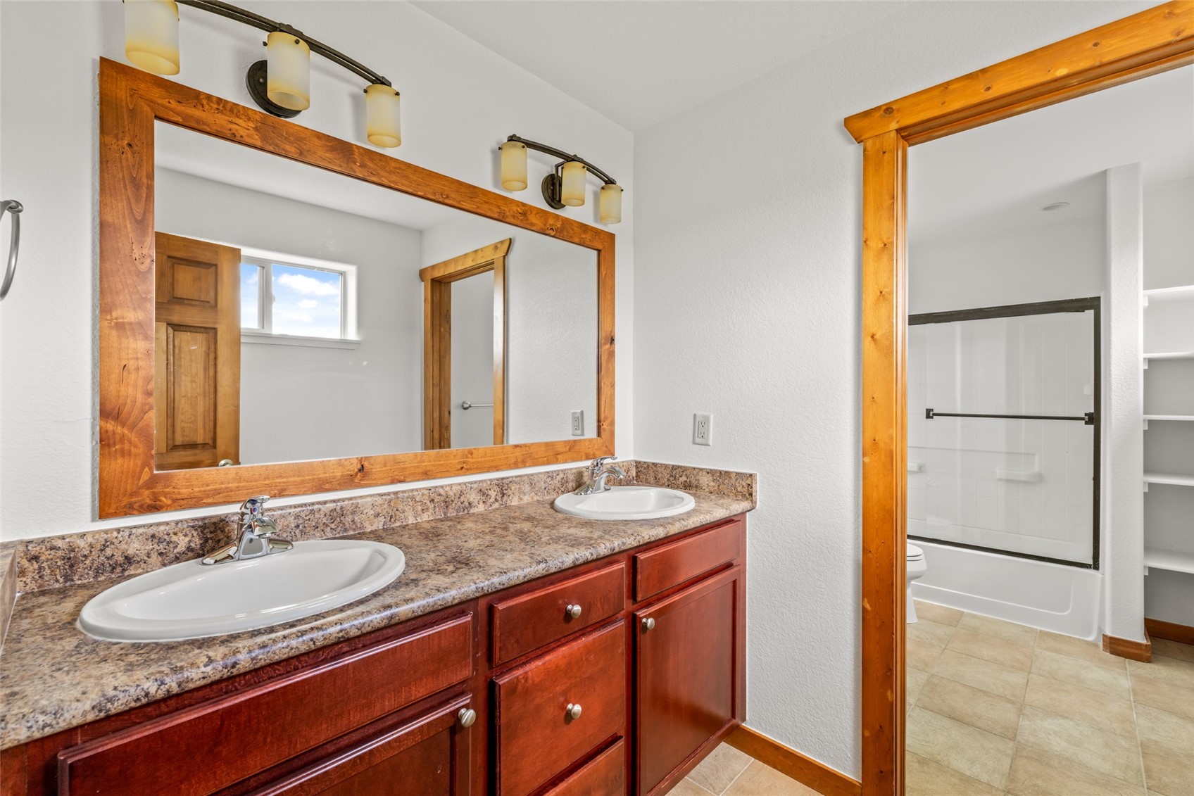127 Oak Ridge Circle, Unit 104 Oak Creek, CO 80467 - Photo 19 of 26 a bathroom with a granite countertop sink and a mirror