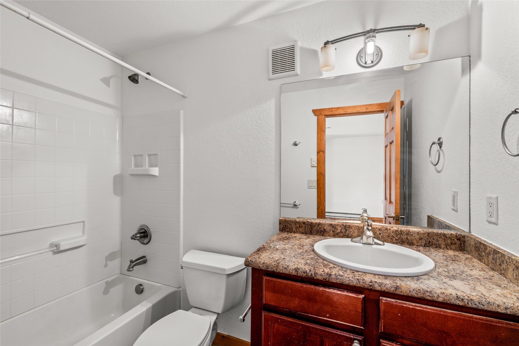 127 Oak Ridge Circle, Unit 104 Oak Creek, CO 80467 - Photo 23 of 26 a bathroom with a granite countertop sink toilet and shower