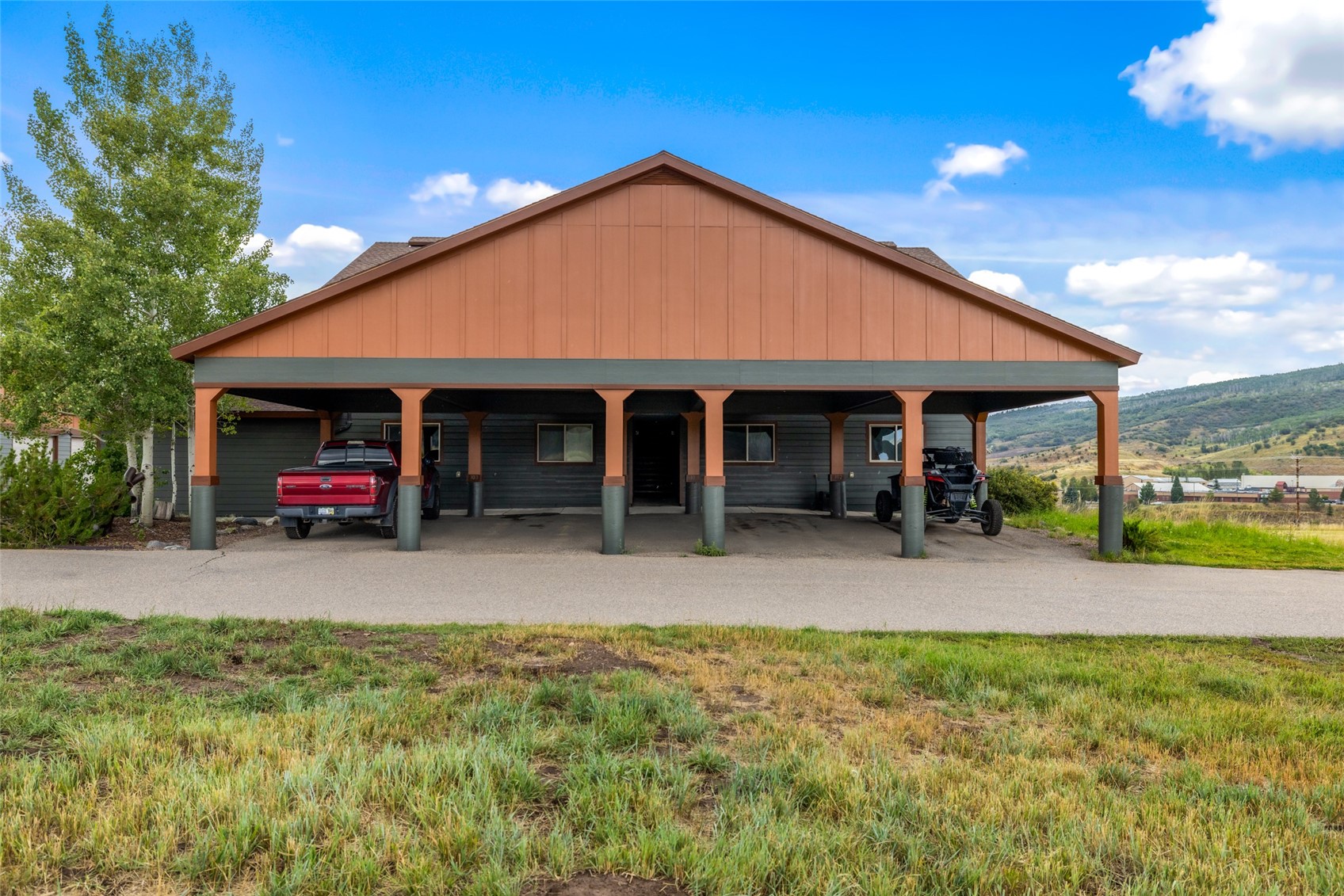 127 Oak Ridge Circle, Unit 104 Oak Creek, CO 80467 - Photo 3 of 26 a view of a house with a yard and porch
