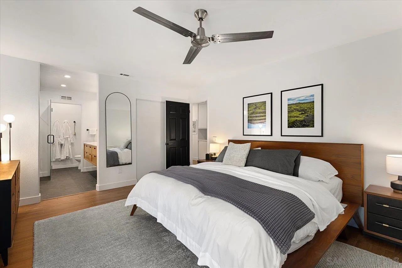 101 Rodney Avenue Encinitas, CA 92024 - Photo 12 of 31 a spacious bedroom with a balcony a bed and a chandelier
