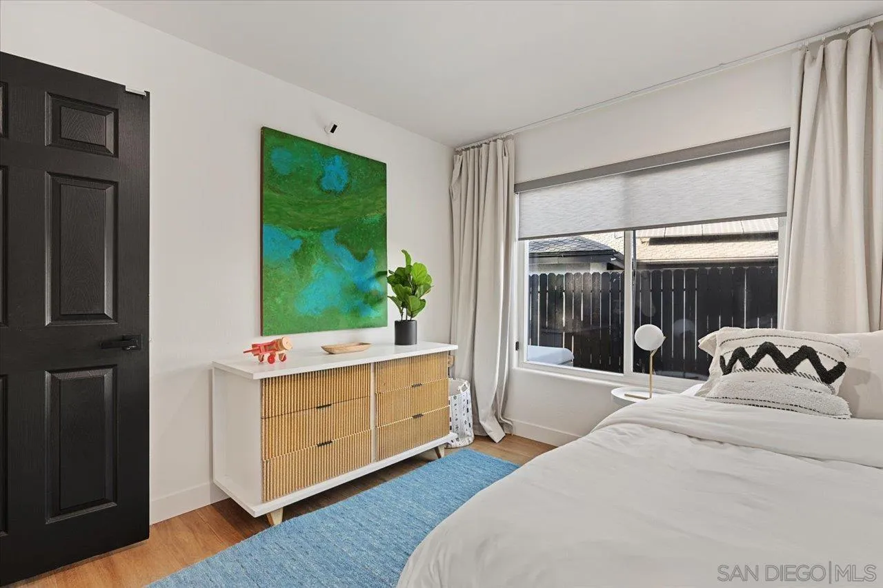 101 Rodney Avenue Encinitas, CA 92024 - Photo 17 of 31 a bedroom with a bed and large windows