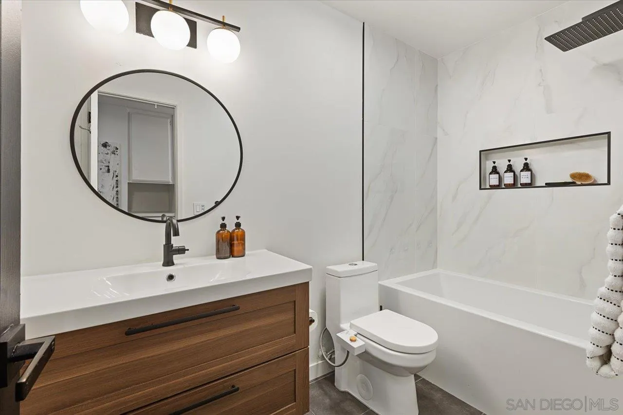 101 Rodney Avenue Encinitas, CA 92024 - Photo 18 of 31 a bathroom with a sink a toilet and a mirror