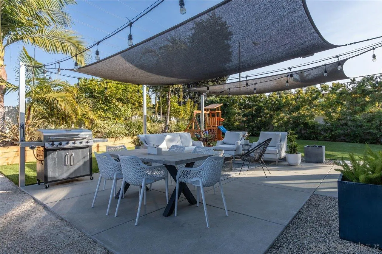 101 Rodney Avenue Encinitas, CA 92024 - Photo 26 of 31 a view of a patio with table and chairs under an umbrella