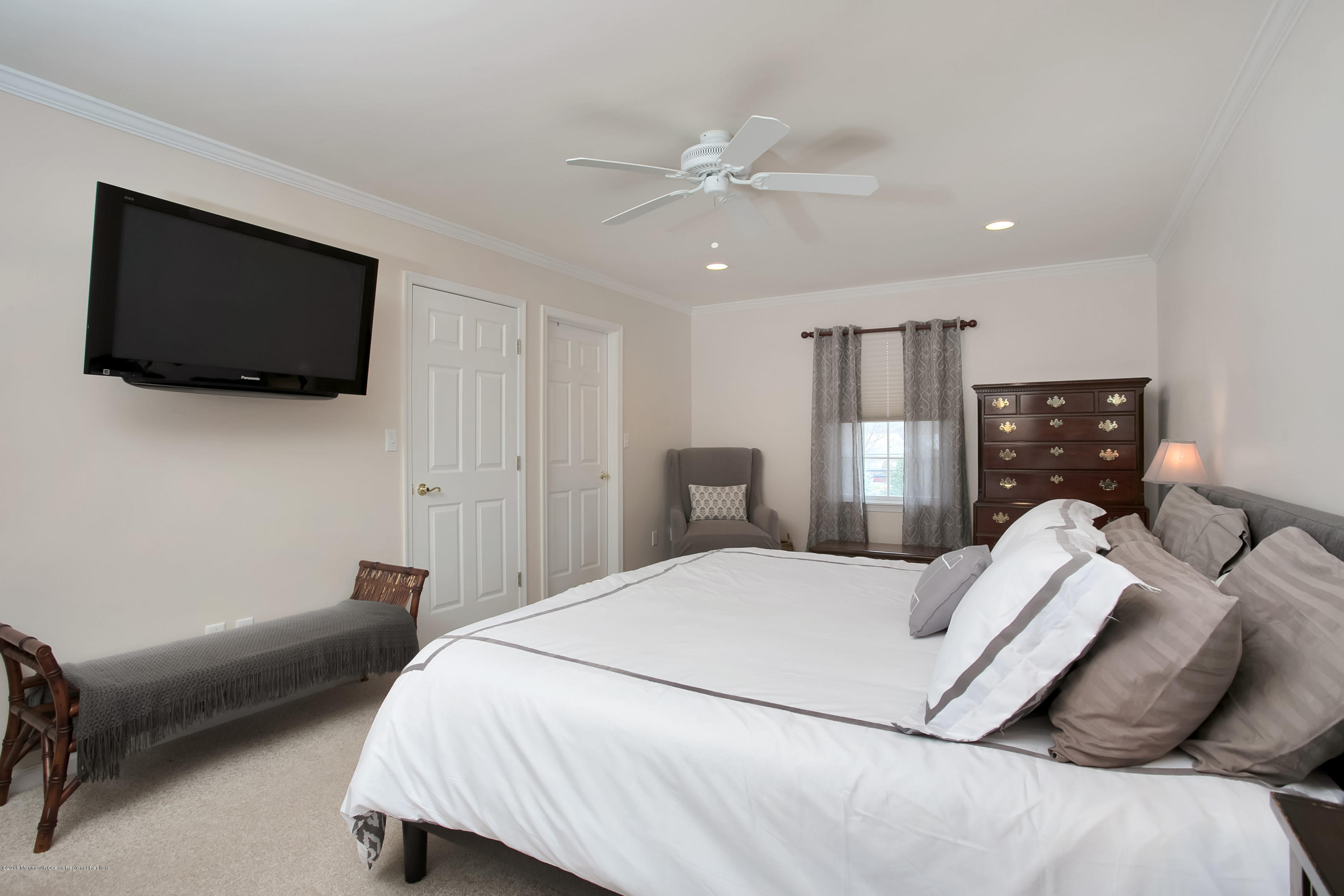 94 Ave Of Two Rivers Rumson, NJ 07760 - Photo 21 of 41 a bedroom with a bed a flat screen tv and a couch