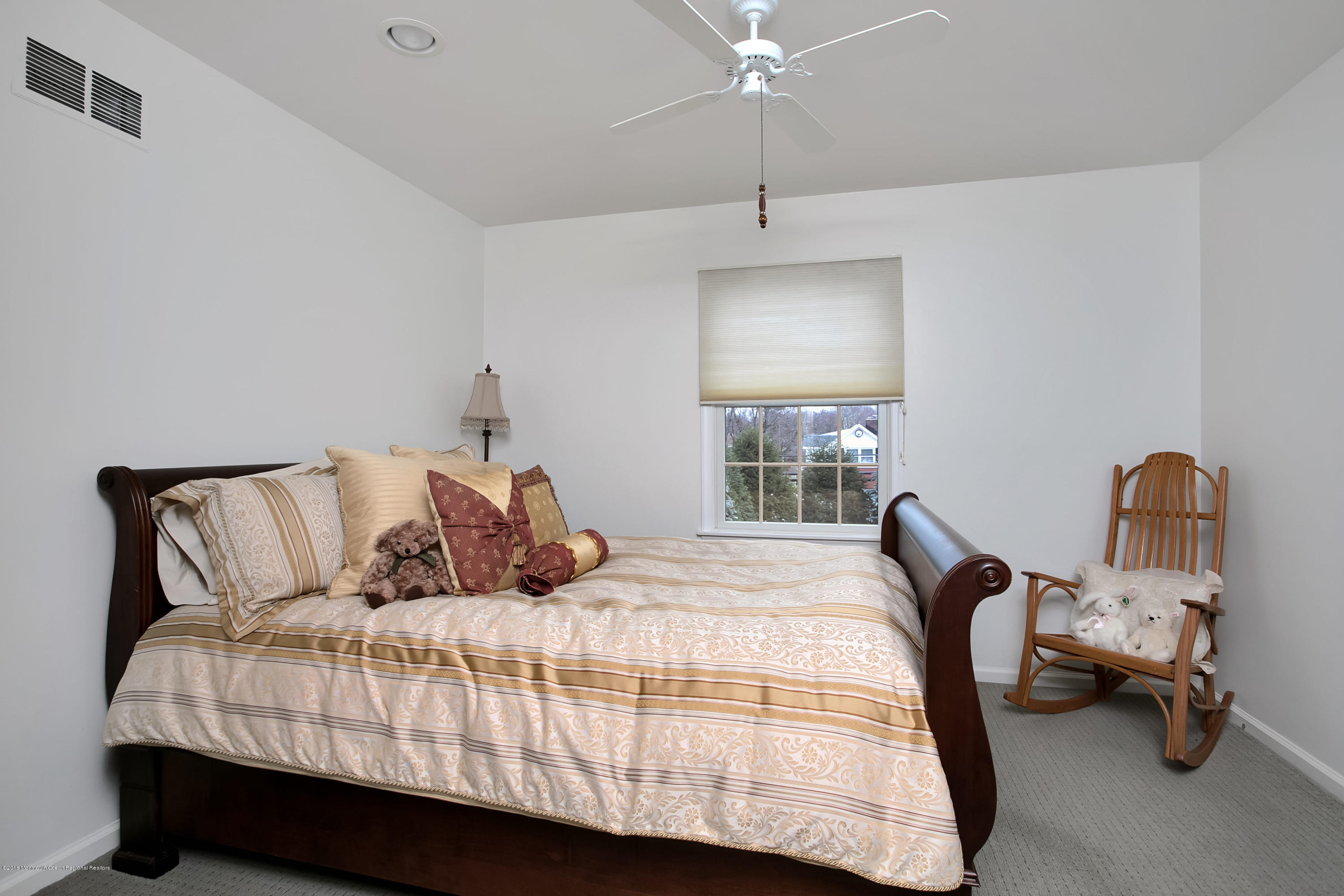 94 Ave Of Two Rivers Rumson, NJ 07760 - Photo 24 of 41 a bedroom with a bed and a chandelier