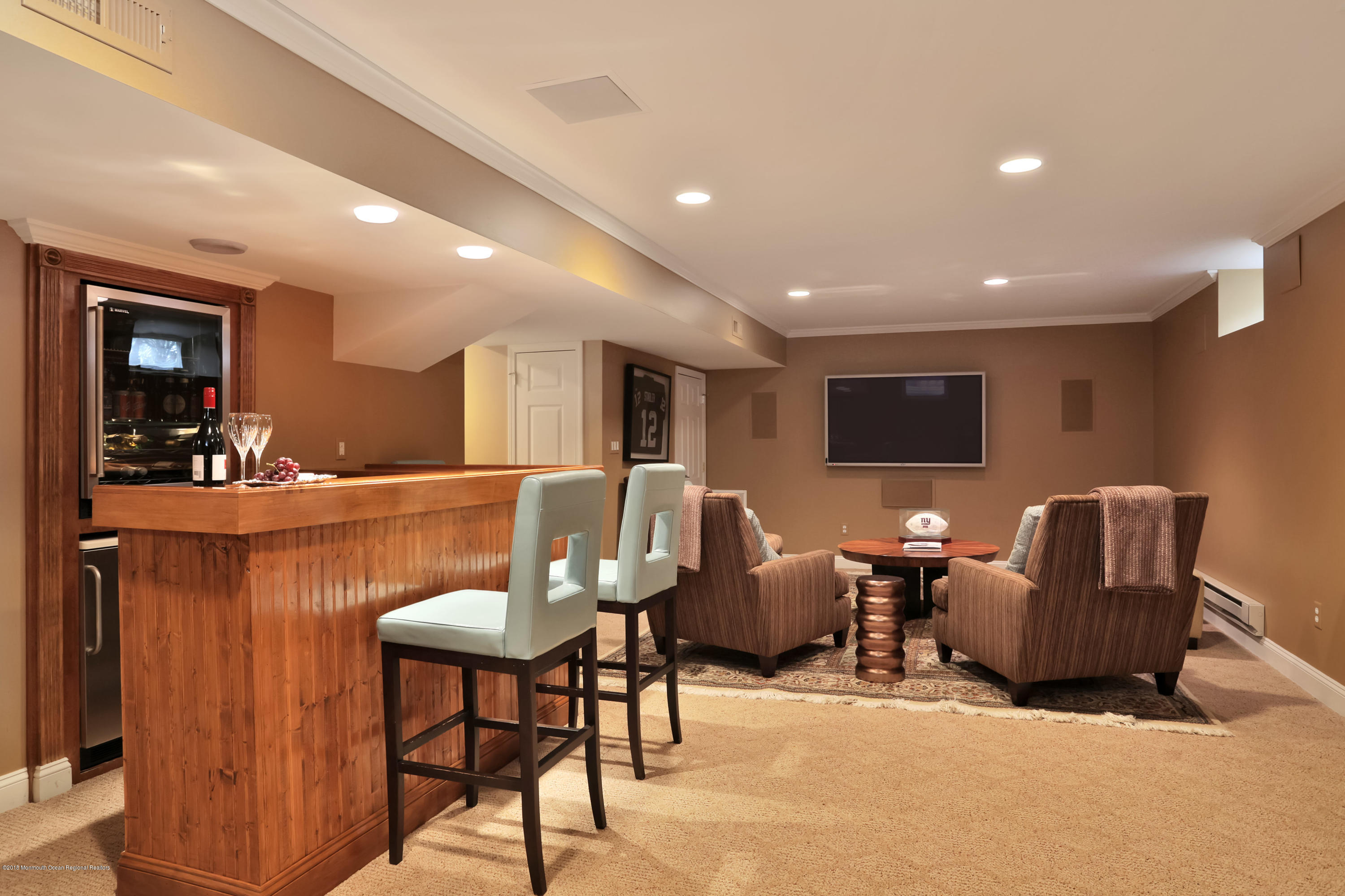 94 Ave Of Two Rivers Rumson, NJ 07760 - Photo 31 of 41 a living room with furniture a wooden floor and a flat screen tv