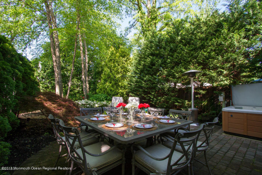 94 Ave Of Two Rivers Rumson, NJ 07760 - Photo 37 of 41 a view of a backyard with table and chairs and potted plants