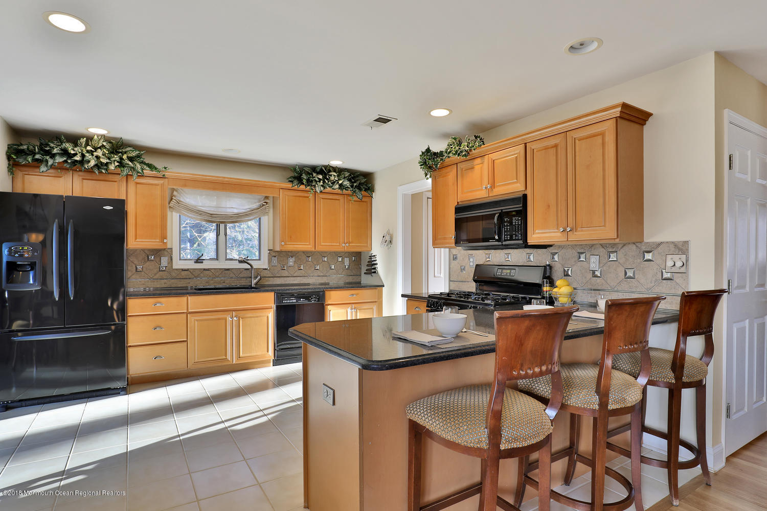 94 Ave Of Two Rivers Rumson, NJ 07760 - Photo 6 of 41 a kitchen with stainless steel appliances granite countertop a stove top oven a sink dishwasher and a microwave oven with cabinets