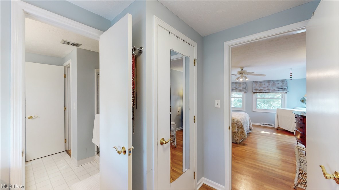 1881 Winchester Road Cleveland, OH 44124 - Photo 15 of 27 Corridor from primary bedroom featuring light hardwood floors, closets and access to updated bathroom.