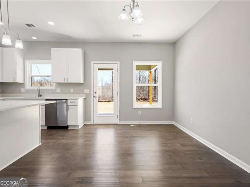 1495 Kansas Jake Road Waco, GA 30182 - Photo 14 of 34 a view of a kitchen with a sink wooden floor and windows