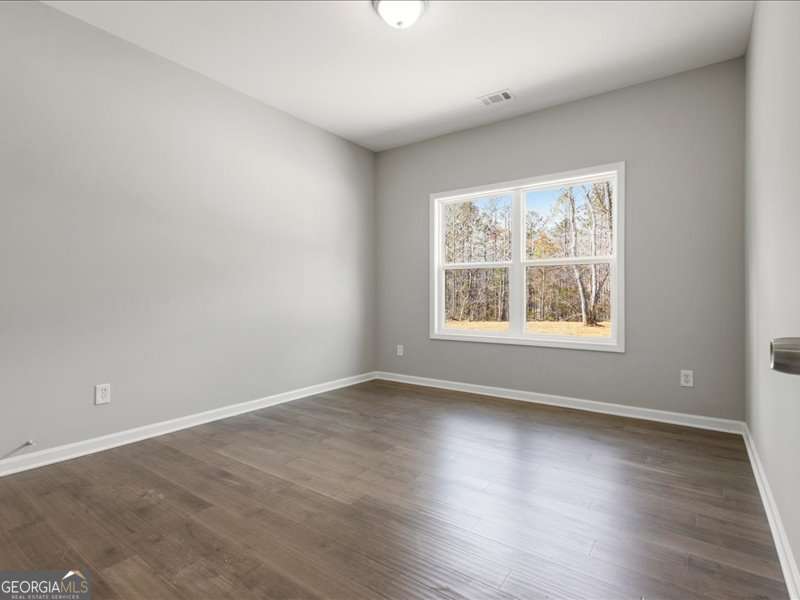 1495 Kansas Jake Road Waco, GA 30182 - Photo 21 of 34 an empty room with wooden floor and windows