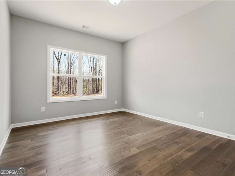 1495 Kansas Jake Road Waco, GA 30182 - Photo 22 of 34 a view of an empty room with wooden floor and a window