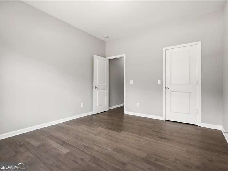 1495 Kansas Jake Road Waco, GA 30182 - Photo 23 of 34 an empty room with wooden floor & closet and windows