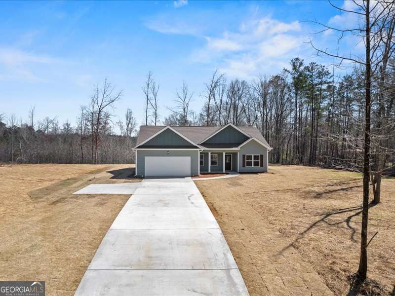 1495 Kansas Jake Road Waco, GA 30182 - Photo 5 of 34 a front view of a house with trees and covered with snow in the background