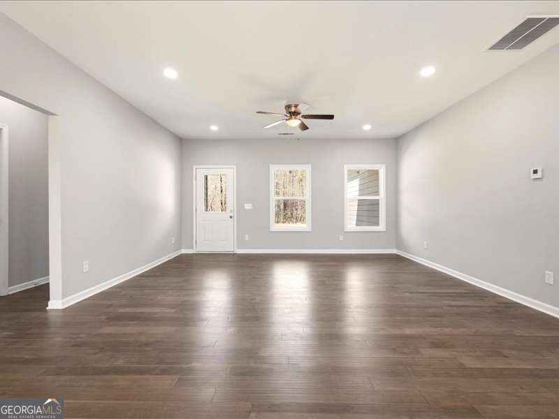 1495 Kansas Jake Road Waco, GA 30182 - Photo 7 of 34 an empty room with wooden floor and windows