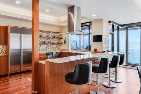 a kitchen with stainless steel appliances granite countertop a sink a stove and a refrigerator
