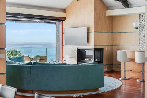 a view of living room with furniture and a fireplace