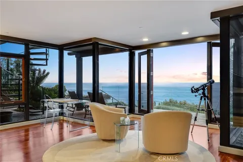 a balcony with furniture and a floor to ceiling window