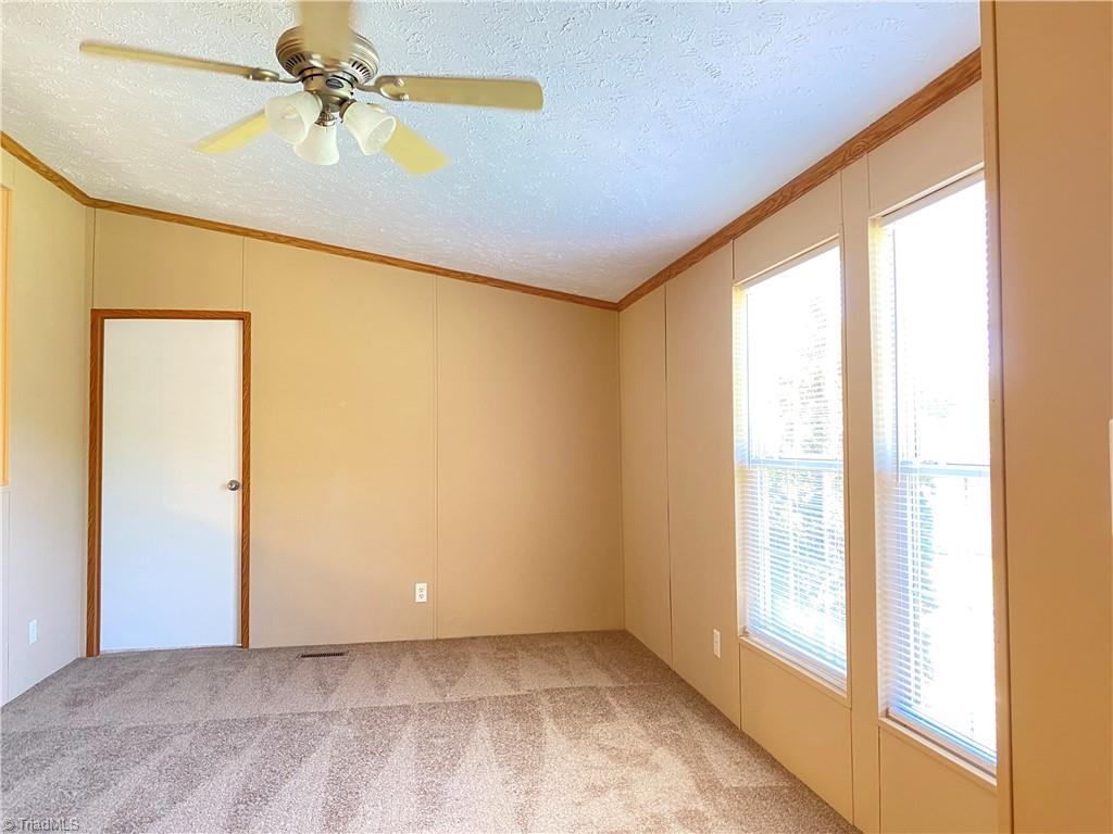 611 Comer Road Stoneville, NC 27048 - Photo 3 of 20 Living Room and entrance to Primary Bedroom