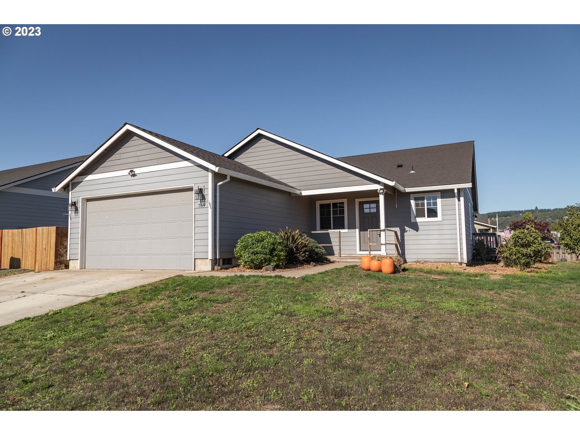 a front view of a house with a garden and yard