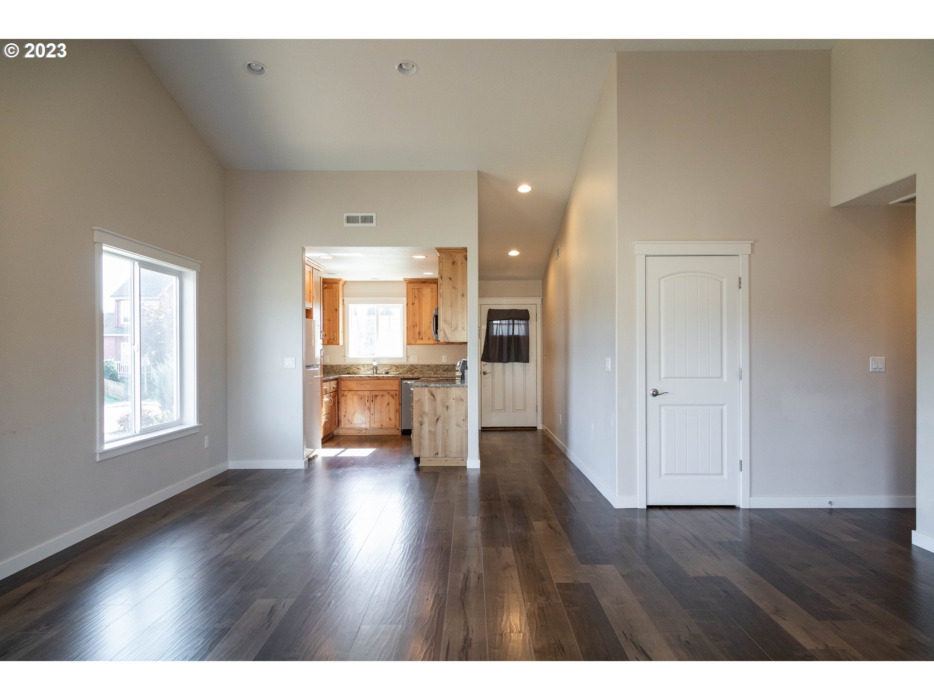 769 Southeast Meadows Loop Sheridan, OR 97378 - Photo 2 of 20 a view of a kitchen with a sink and dishwasher kitchen view with wooden floor